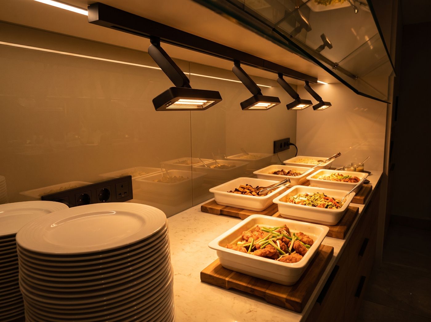 Food held under heat lamps on a service line